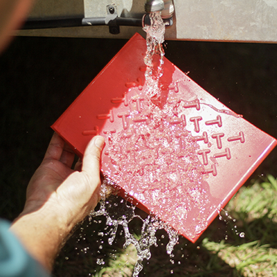 Redfoot Levelling - A man is holding Redfoot Levelling Super Chocks.