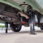 Under-chassis photo of Redfoot Levelling jacks extended