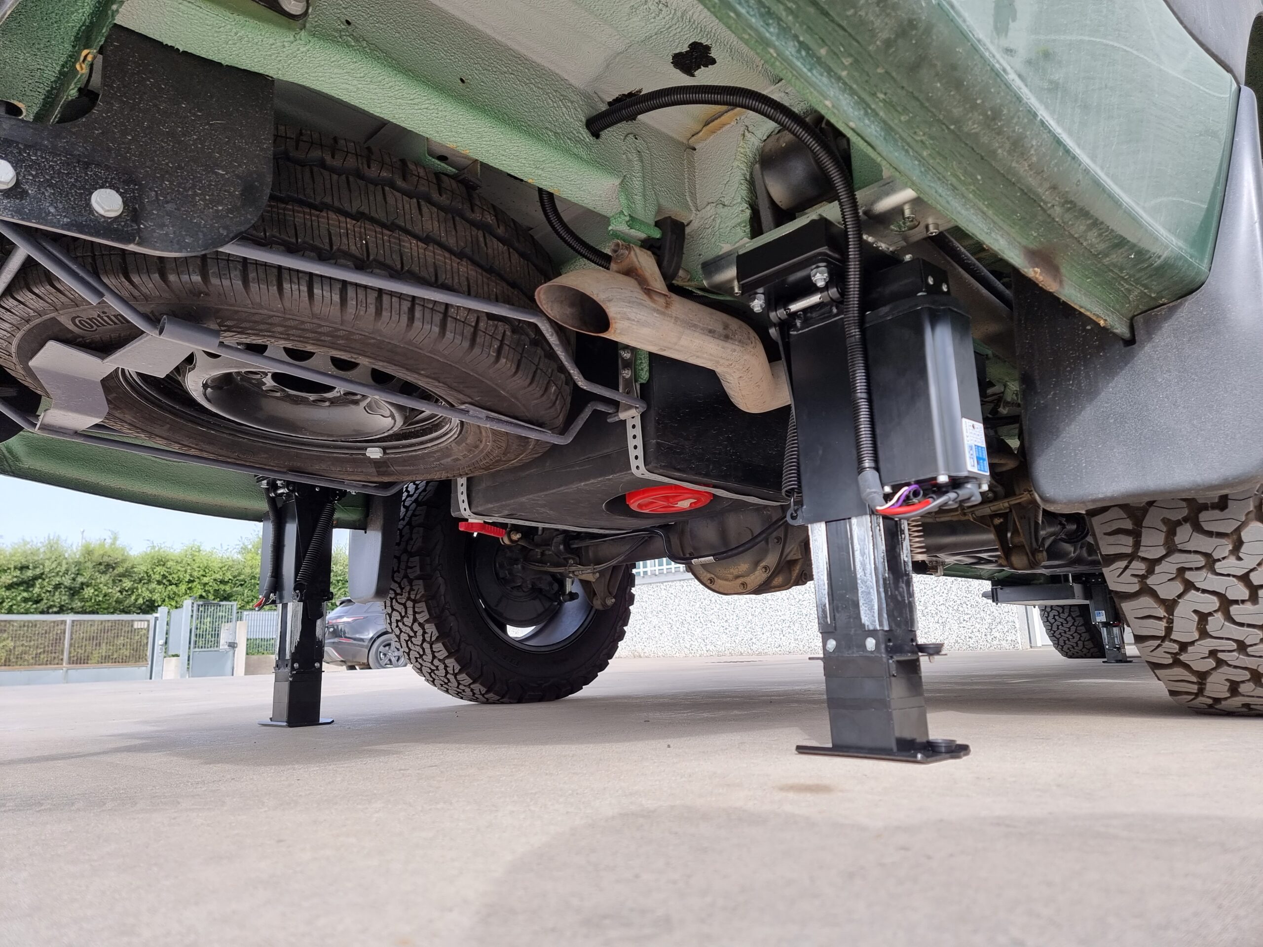 Under-chassis photo of Redfoot Levelling jacks extended